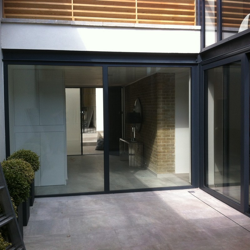 Floor-to-ceiling sliding doors opening to courtyard in Milton Keynes
